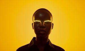 futuristic portrait of woman with glowing eyes and yellow background picjumbo com scaled
